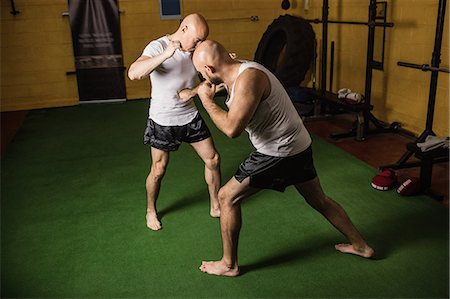 simsearch:400-03984387,k - Thai boxers practicing boxing in the fitness studio Stock Photo - Premium Royalty-Free, Code: 6109-08765028