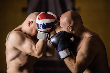 simsearch:400-03984387,k - Thai boxers practicing boxing in the fitness studio Stock Photo - Premium Royalty-Free, Code: 6109-08765033