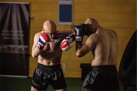 simsearch:400-03984387,k - Thai boxers practicing boxing in the fitness studio Stock Photo - Premium Royalty-Free, Code: 6109-08765032