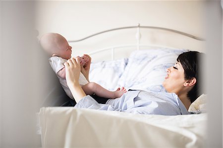 simsearch:6109-08390041,k - Mother playing with her baby in bedroom at home Stock Photo - Premium Royalty-Free, Code: 6109-08700717