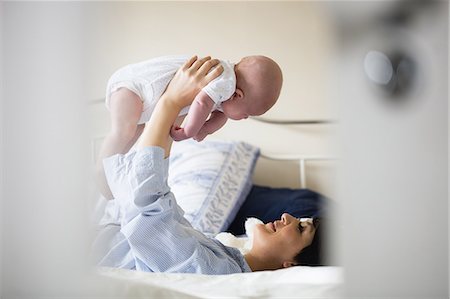 simsearch:6109-08390041,k - Mother playing with her baby in bedroom at home Stock Photo - Premium Royalty-Free, Code: 6109-08700716