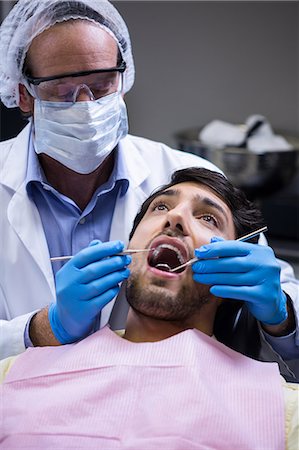 dentist - Dentist examining a patient with tools at dental clinic Stock Photo - Premium Royalty-Free, Code: 6109-08700858