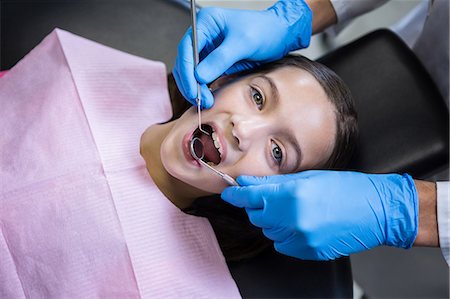 dental girls - Dentist examining a young patient with tools at dental clinic Stock Photo - Premium Royalty-Free, Code: 6109-08700874