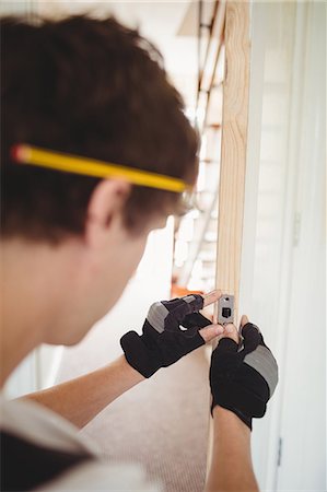 fingerless gloves - Carpenter working on a wooden door at home Stock Photo - Premium Royalty-Free, Code: 6109-08701005