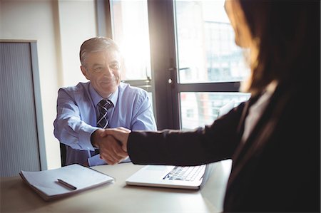 professional hand shake - Businessman shaking hands with colleague in office Stock Photo - Premium Royalty-Free, Code: 6109-08701295