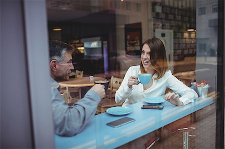 simsearch:6109-08690411,k - Man and woman having coffee in the cafeteria Stock Photo - Premium Royalty-Free, Code: 6109-08701367