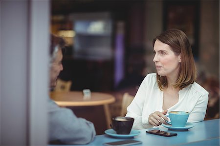 simsearch:6109-08690411,k - Man and woman having conversation in the cafeteria Stock Photo - Premium Royalty-Free, Code: 6109-08701373