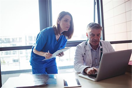 simsearch:6109-08804356,k - Doctor discussing with nurse over laptop at the hospital Stock Photo - Premium Royalty-Free, Code: 6109-08701316