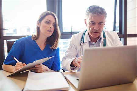 simsearch:6109-08804356,k - Doctor discussing with nurse over laptop at the hospital Stock Photo - Premium Royalty-Free, Code: 6109-08701318