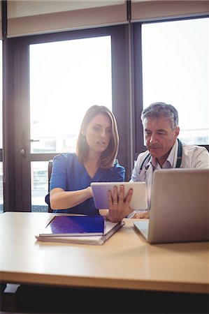 simsearch:6109-08804356,k - Doctor discussing with nurse over digital tablet at the hospital Stock Photo - Premium Royalty-Free, Code: 6109-08701324