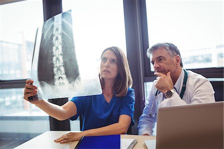 simsearch:6109-08804356,k - Doctor and nurse examining x-ray at the hospital Stock Photo - Premium Royalty-Free, Code: 6109-08701325