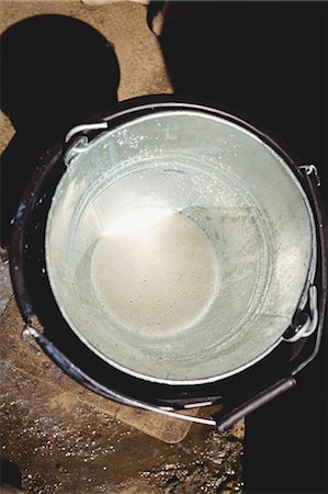 Empty steel bucket in barn Stock Photo - Premium Royalty-Free, Code: 6109-08701485
