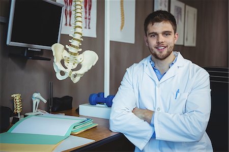 pelvic therapy - Portrait of physiotherapist sitting at his desk in the clinic Stock Photo - Premium Royalty-Free, Code: 6109-08701768