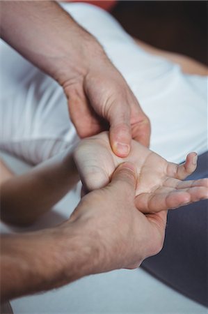 Close-up of physiotherapist massaging hand of a female patient in the clinic Stock Photo - Premium Royalty-Free, Code: 6109-08701796