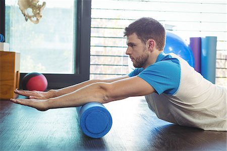 Man performing stretching exercise in the clinic Stock Photo - Premium Royalty-Free, Code: 6109-08701727