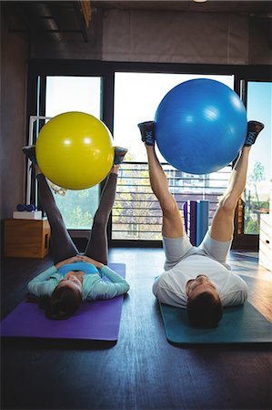 physical - Man and woman holding exercise ball between legs in the clinic Stock Photo - Premium Royalty-Free, Code: 6109-08701737