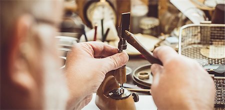 Horologist repairing a pocket watch in the workshop Stock Photo - Premium Royalty-Free, Code: 6109-08705178