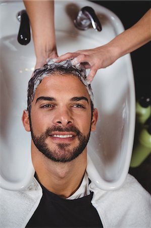 shampoo - Smiling man getting his hair wash at a salon Stock Photo - Premium Royalty-Free, Code: 6109-08705201