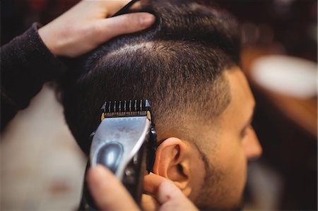 styling - Man getting his hair trimmed with trimmer in barber shop Stock Photo - Premium Royalty-Free, Code: 6109-08705374