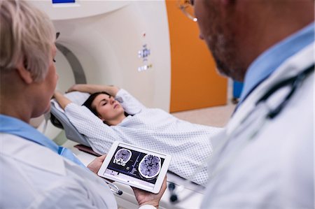 Doctors examining brain mri scan on digital tablet at hospital Stock Photo - Premium Royalty-Free, Code: 6109-08720145