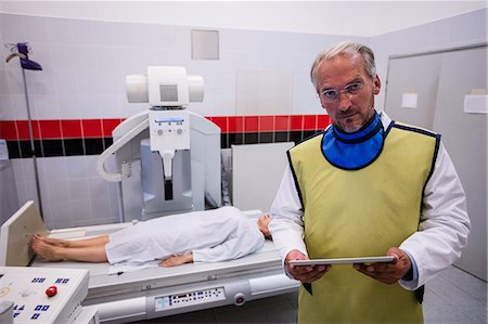 radiographs - Doctor holding digital tablet and patient lying on x ray machine in hospital Stock Photo - Premium Royalty-Free, Code: 6109-08720162