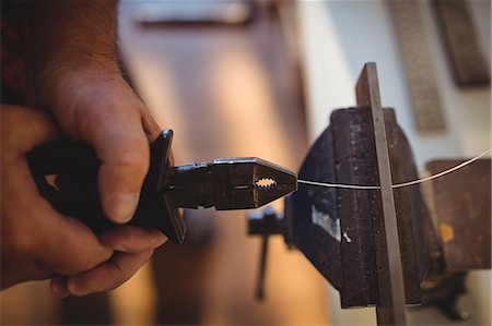 Close-up of goldsmith working in workshop Stock Photo - Premium Royalty-Free, Code: 6109-08720452