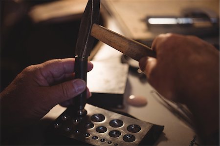 Close-up of goldsmith making hole in sinking at workshop Stock Photo - Premium Royalty-Free, Code: 6109-08720429