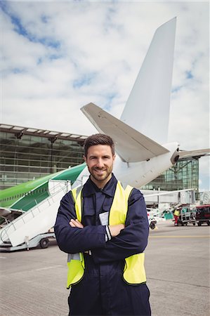Portrait of airport ground crew standing on runway at airport terminal Stock Photo - Premium Royalty-Free, Code: 6109-08722694