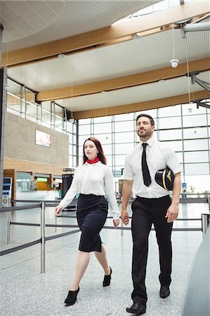 Pilot and flight attendant walking at the airport Stock Photo - Premium Royalty-Free, Code: 6109-08722744