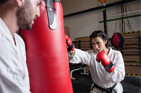 practise - Man and woman practicing karate with punching bag in studio Stock Photo - Premium Royalty-Free, Code: 6109-08739194