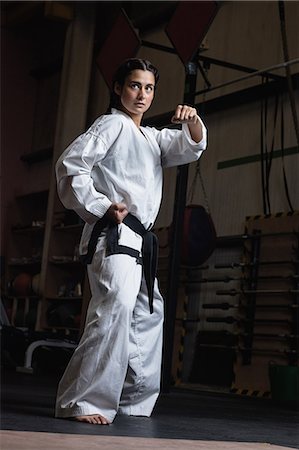 Woman practicing karate in fitness studio Stock Photo - Premium Royalty-Free, Code: 6109-08739242