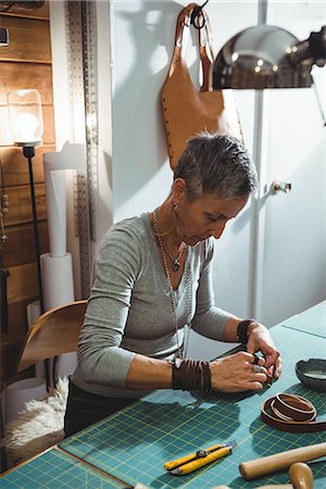 entrepreneur focus - Attentive craftswoman working in workshop Stock Photo - Premium Royalty-Free, Code: 6109-08802333