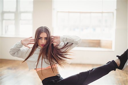 simsearch:6109-08802676,k - Pretty woman practising hip hop dance in studio Stock Photo - Premium Royalty-Free, Code: 6109-08802655