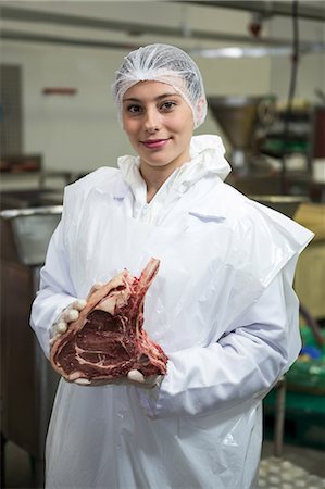 peeling - Portrait of female butcher holding meat at meat factory Stock Photo - Premium Royalty-Free, Code: 6109-08802941