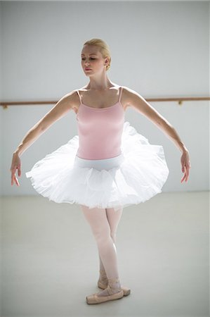 simsearch:400-07725556,k - Ballerina practicing a ballet dance in ballet studio Stock Photo - Premium Royalty-Free, Code: 6109-08803016
