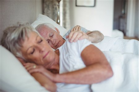 simsearch:693-03707745,k - Senior couple sleeping on bed in bedroom Stock Photo - Premium Royalty-Free, Code: 6109-08803177