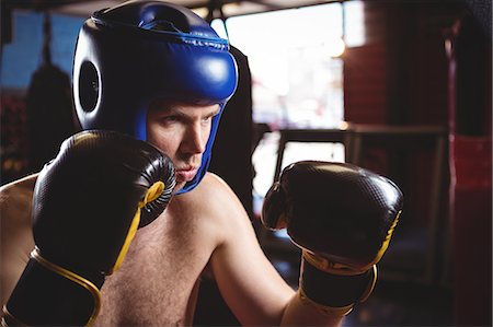 Boxer performing a boxing stance in fitness studio Stock Photo - Premium Royalty-Free, Code: 6109-08803787
