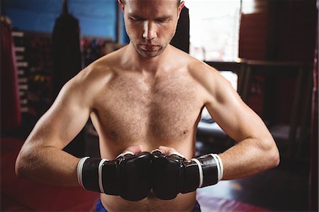 Boxer performing a boxing stance in fitness studio Stock Photo - Premium Royalty-Free, Code: 6109-08803788