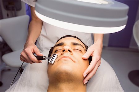 simsearch:6109-08804015,k - Dermatologist performing laser hair removal on patient face in clinic Stock Photo - Premium Royalty-Free, Code: 6109-08803809