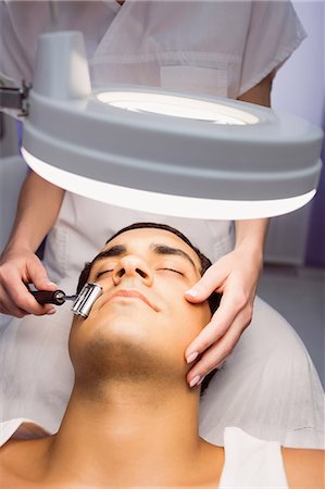 simsearch:6109-08804015,k - Dermatologist performing laser hair removal on patient face in clinic Stock Photo - Premium Royalty-Free, Code: 6109-08803810