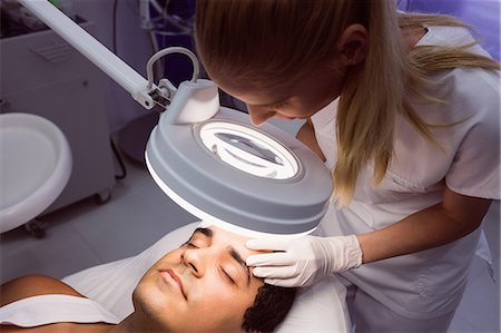 simsearch:6109-08804015,k - Doctor examining mans face for cosmetic treatment at clinic Stock Photo - Premium Royalty-Free, Code: 6109-08803817