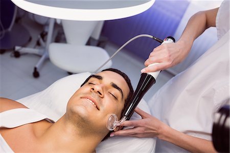 simsearch:6109-08804015,k - Dermatologist performing laser hair removal on patient face in clinic Stock Photo - Premium Royalty-Free, Code: 6109-08803814