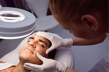 simsearch:6109-08804015,k - Doctor examining mans face for cosmetic treatment at clinic Stock Photo - Premium Royalty-Free, Code: 6109-08803816