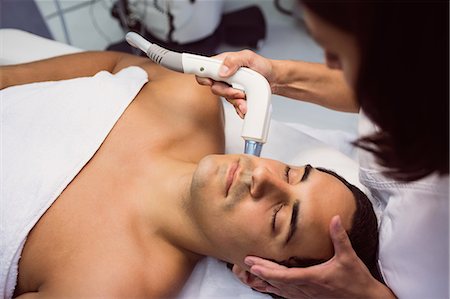 simsearch:6109-08804015,k - Patient receiving facial treatment at clinic Stock Photo - Premium Royalty-Free, Code: 6109-08803833