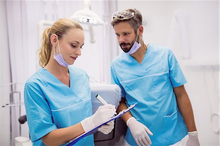 safety documents - Dentists interacting with each other at dental clinic Stock Photo - Premium Royalty-Free, Code: 6109-08803964