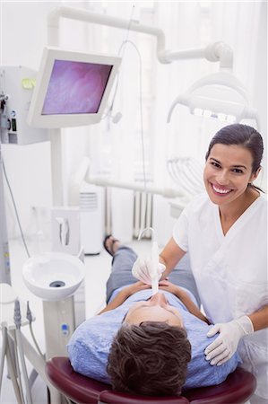 dentist with patient in exam room - Portrait of female dentist examining patient in dental clinic Stock Photo - Premium Royalty-Free, Code: 6109-08803992