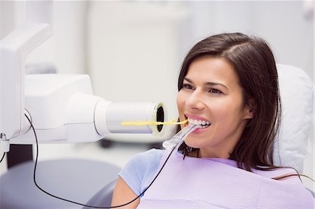Female patient receiving dental treatment at dental clinic Stock Photo - Premium Royalty-Free, Code: 6109-08803930