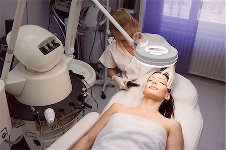 simsearch:6109-08804015,k - Dermatologist performing laser hair removal on patient face in clinic Stock Photo - Premium Royalty-Free, Code: 6109-08804040