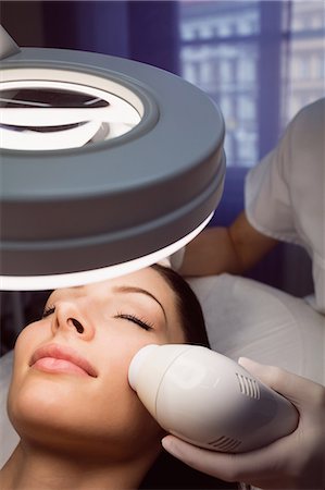 simsearch:6109-08804015,k - Dermatologist giving facial massage to patient through sonic lifting in clinic Stock Photo - Premium Royalty-Free, Code: 6109-08804046