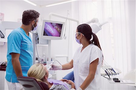 dentist with patient in exam room - Male and female dentist examining patient in dental clinic Stock Photo - Premium Royalty-Free, Code: 6109-08804000